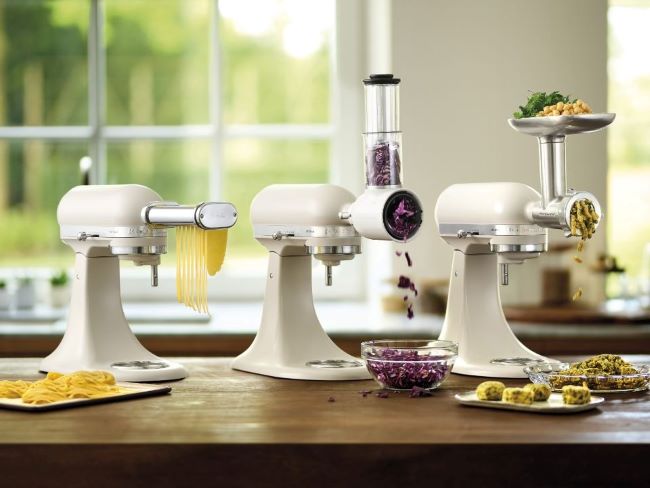 Close-up of KitchenAid pasta rollers and cutters attached to a stand mixer.